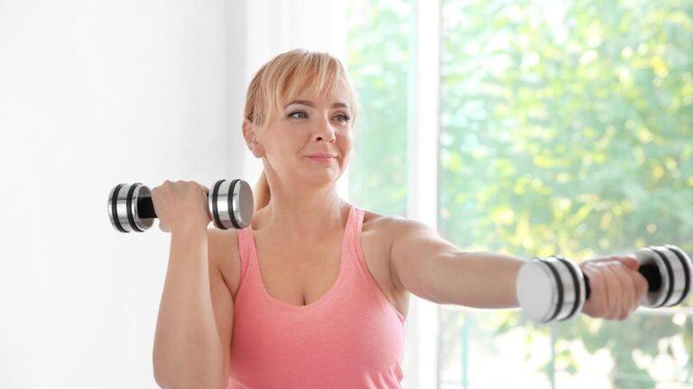 A woman exercising and using small weights to fight off calorie deficit diets.