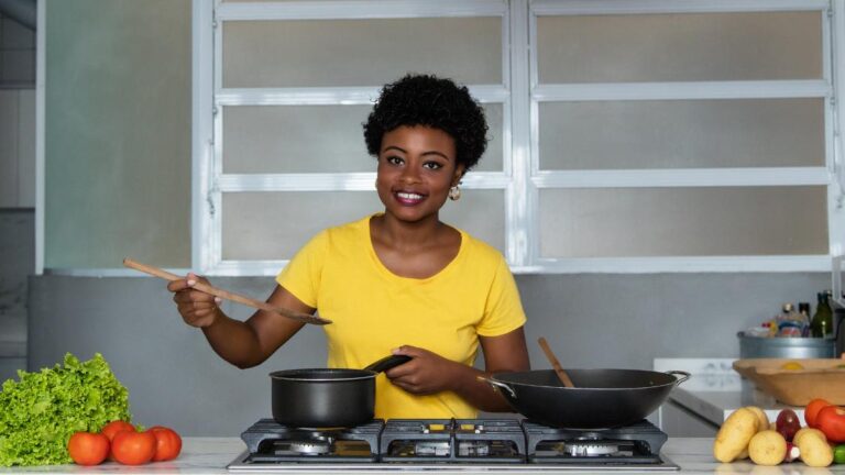 A women cooking in her kitchen while looking into the question, does spicy food really boost metabolism.