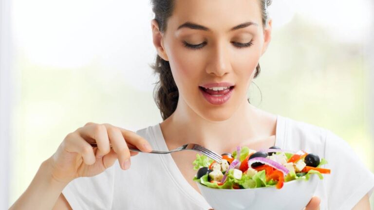 A woman eating a healthy bowl of food to show nutrition counts when losing weight.