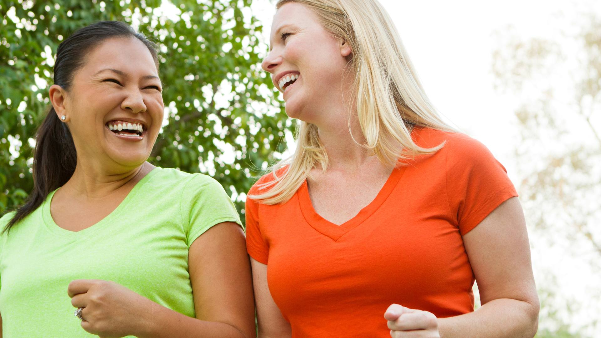 Two women smiling and walking side-by-side, answering the question "how to lose 10 pounds in 2 weeks."